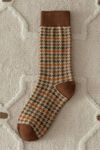 Patterned sock with brown accents on a textured surface