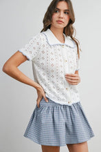 Load image into Gallery viewer, Woman wearing a white lace top and blue plaid skirt on a gray background