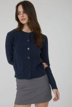 Load image into Gallery viewer, Woman wearing a navy blue cardigan over a gray skirt on a white background