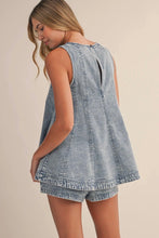 Load image into Gallery viewer, Woman wearing a denim romper against a beige background