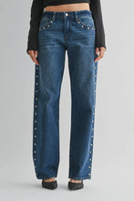 Load image into Gallery viewer, Blue jeans with decorative buttons on a gray background