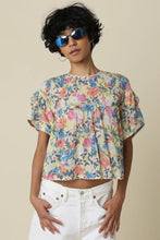 Load image into Gallery viewer, Woman wearing a floral blouse and sunglasses against a beige background