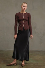Load image into Gallery viewer, Woman wearing a brown ribbed sweater and black satin skirt against a plain background