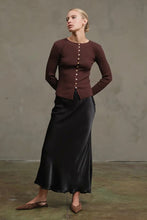 Load image into Gallery viewer, Woman wearing a brown ribbed sweater and black skirt against a plain background