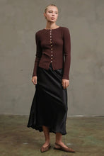 Load image into Gallery viewer, Woman wearing a brown ribbed sweater and black skirt against a plain background