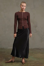 Load image into Gallery viewer, Woman wearing a brown ribbed sweater and black satin skirt against a plain background