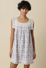 Load image into Gallery viewer, Woman wearing a floral dress with lace details on a beige background