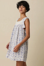 Load image into Gallery viewer, Woman wearing a floral dress against a beige background