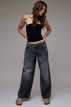 Load image into Gallery viewer, Woman wearing wide-leg jeans and a black top against a plain background