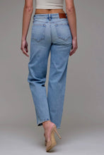 Load image into Gallery viewer, Person wearing light blue jeans on a plain background