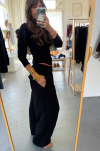 Person wearing a black outfit in a clothing store