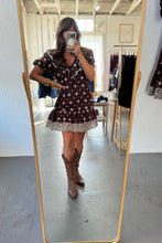 Load image into Gallery viewer, Person taking a mirror selfie wearing a brown dress with white polka dots and brown boots in a store.
