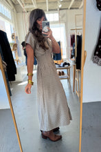 Load image into Gallery viewer, Woman taking a mirror selfie wearing a long patterned dress in a clothing store.