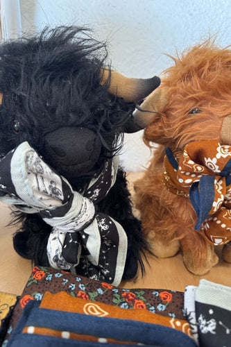 Close-up of a plush horse with decorative elements on a white background