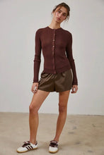 Load image into Gallery viewer, Woman wearing a brown ribbed sweater and gold shorts against a plain background