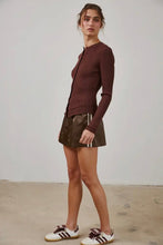 Load image into Gallery viewer, Woman wearing a brown ribbed sweater and leather skirt with white sneakers on a plain background