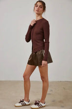 Load image into Gallery viewer, Woman wearing a brown sweater and leather shorts standing against a plain background