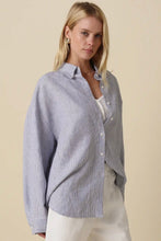 Load image into Gallery viewer, Woman wearing a light blue striped shirt against a beige background