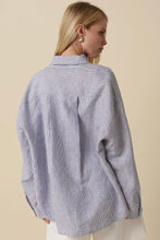 Load image into Gallery viewer, Person wearing a light blue striped shirt against a beige background