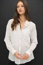 Load image into Gallery viewer, Woman wearing a white shirt against a black background