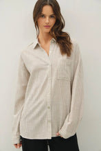 Load image into Gallery viewer, Woman wearing a beige button-up shirt against a white background