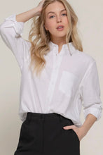Load image into Gallery viewer, Woman wearing a white shirt and black pants against a plain background