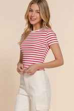 Load image into Gallery viewer, Woman wearing a red and white striped shirt with beige pants on a beige background