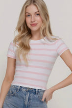 Load image into Gallery viewer, Woman wearing a pink and white striped shirt with blue jeans on a plain background