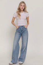 Load image into Gallery viewer, Woman wearing a striped shirt and blue jeans against a plain background