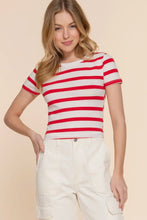 Load image into Gallery viewer, Woman wearing a red and white striped shirt with beige pants on a beige background