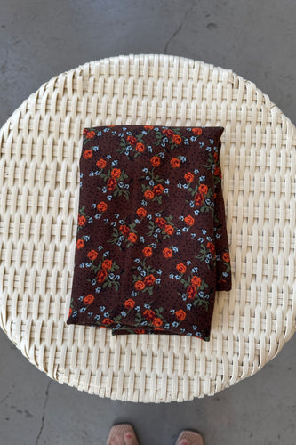 Floral-patterned fabric on a woven surface