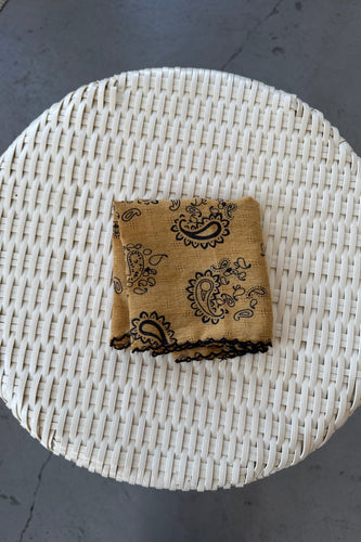 Burlap bag with black patterns on a woven mat