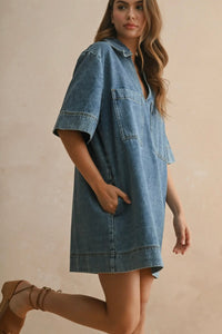 Woman wearing a denim dress on a beige background