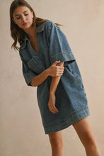 Load image into Gallery viewer, Woman wearing a denim dress against a beige background