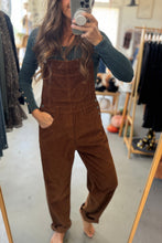 Load image into Gallery viewer, Person wearing brown corduroy overalls taking a mirror selfie in a clothing store.