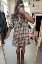 Load image into Gallery viewer, Woman taking a mirror selfie wearing a plaid dress and brown boots in a clothing store.