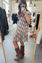 Load image into Gallery viewer, Woman taking a mirror selfie wearing a plaid dress and brown boots in a clothing store.