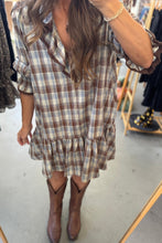Load image into Gallery viewer, Woman wearing a plaid dress with ruffled sleeves and hem in a clothing store.