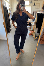 Load image into Gallery viewer, Person wearing a black outfit in a clothing store