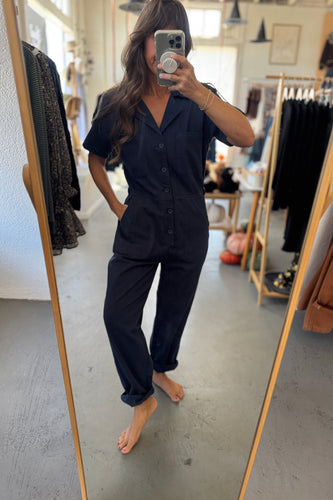Person wearing a black outfit in a clothing store