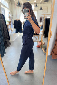 Person wearing a navy outfit in a clothing store