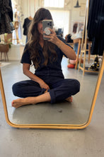 Load image into Gallery viewer, Woman taking a mirror selfie wearing a navy outfit in a store.