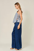 Load image into Gallery viewer, Woman wearing a checkered top and blue wide-leg pants on a plain background