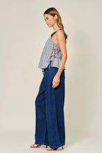 Load image into Gallery viewer, Woman wearing a checkered top and wide-leg jeans on a plain background
