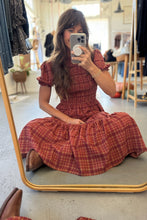 Load image into Gallery viewer, Woman taking a mirror selfie wearing a red plaid dress in a clothing store.