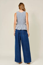Load image into Gallery viewer, Woman wearing a checkered top and blue wide-leg pants on a plain background