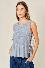 Load image into Gallery viewer, Woman wearing a sleeveless checkered top with a beige background