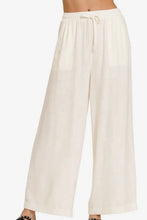 Load image into Gallery viewer, White wide-leg pants on a white background