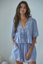 Load image into Gallery viewer, Woman wearing a light blue embroidered dress against a plain background