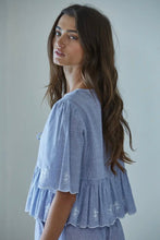 Load image into Gallery viewer, Woman wearing a light blue embroidered top against a plain background